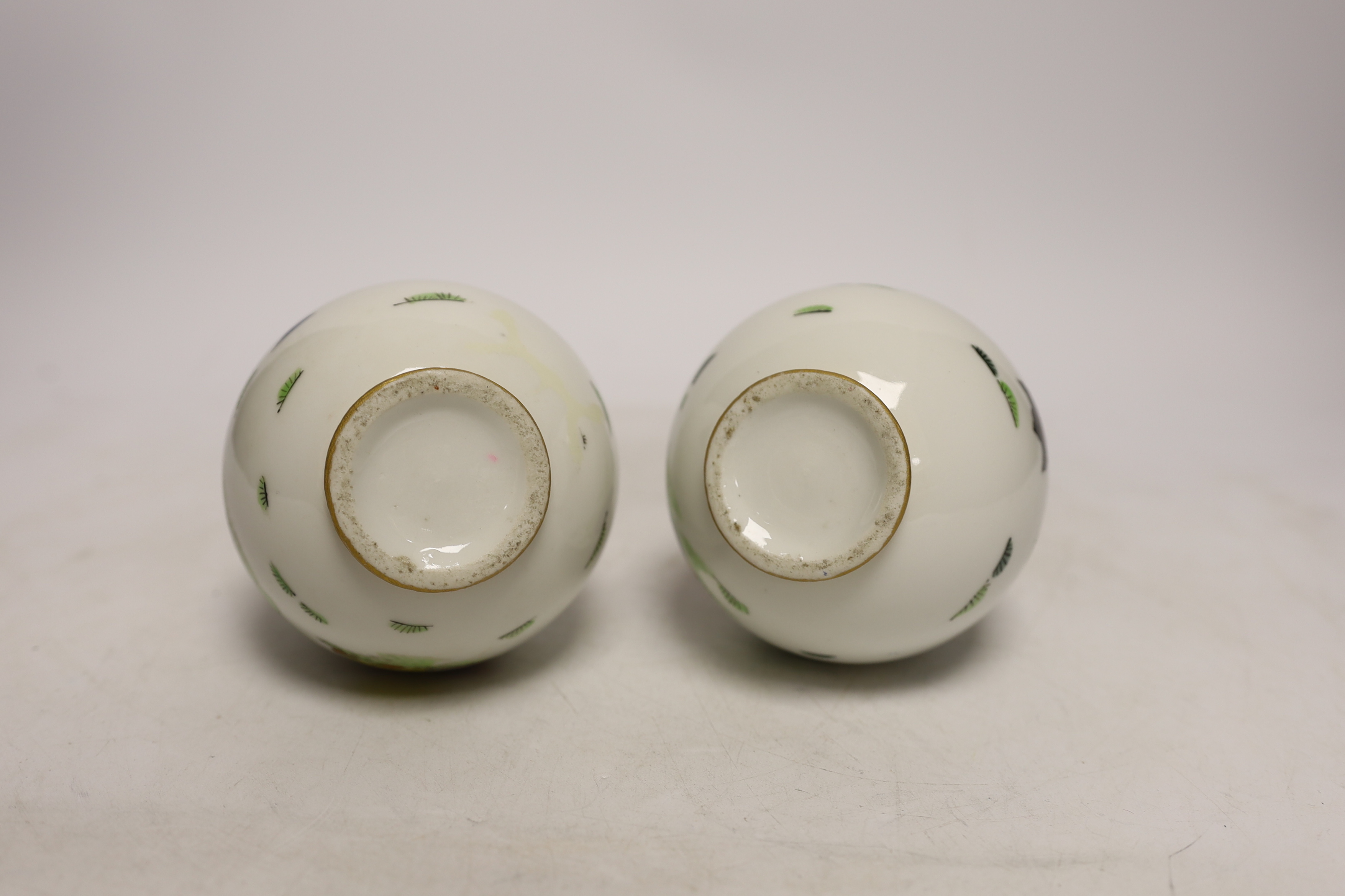 A pair of Continental porcelain bottle neck vases, 17cm high